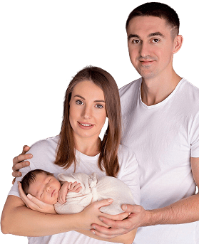 Young couple holding their newborn baby, happy parents with infant at home