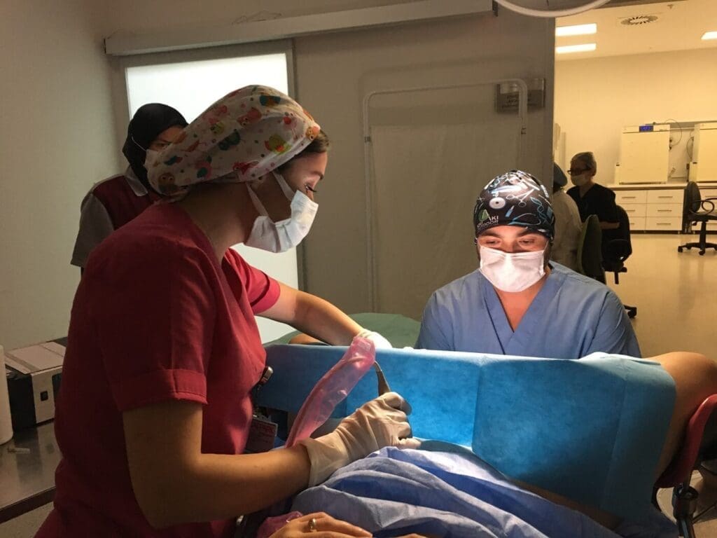 Dentists performing a dental procedure in a clinic with surgical masks